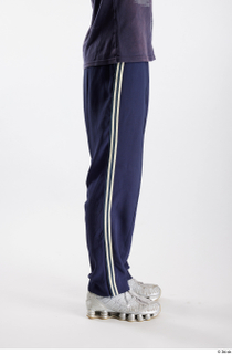 Urien  1 blue track pants dressed flexing leg side…